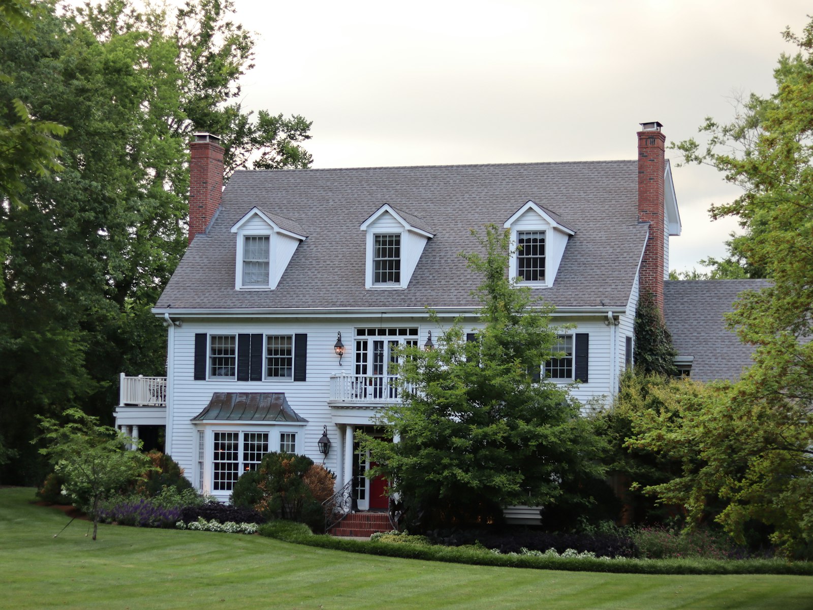 A white colonial-style house with black shutters