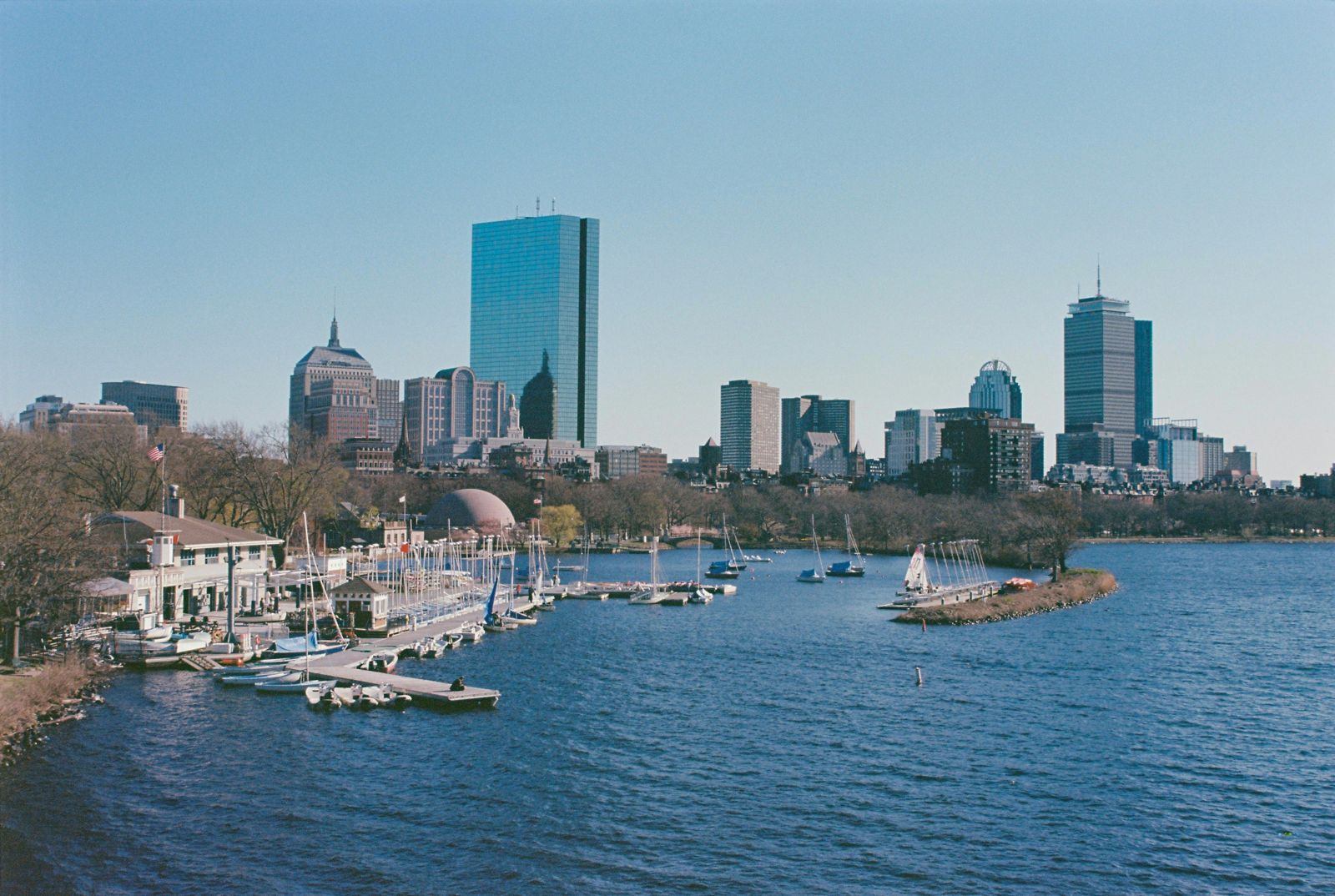 Boston skyline across the Charles River with sailboats at their moorings
